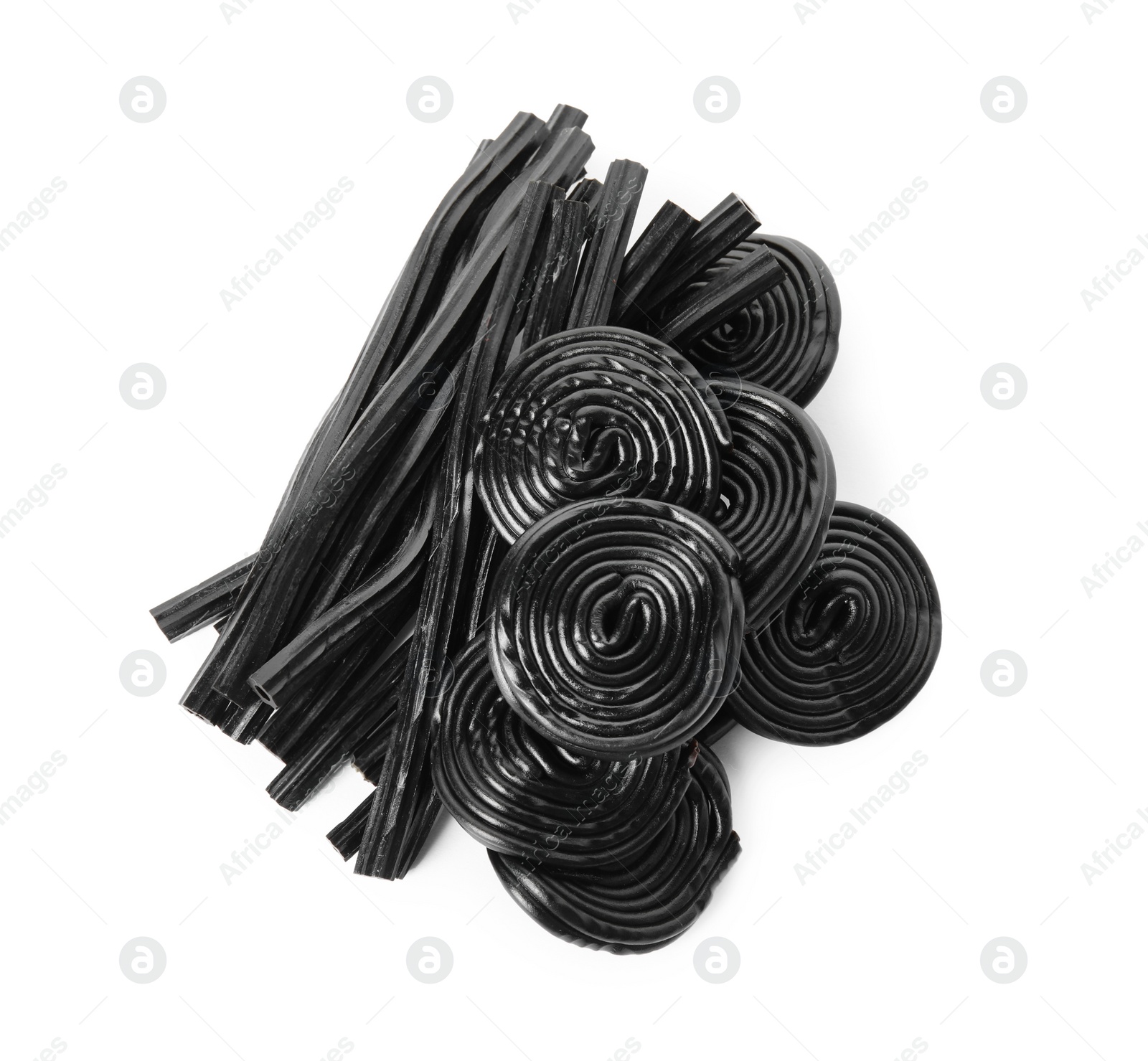 Photo of Pile of tasty liquorice candies on white background, top view