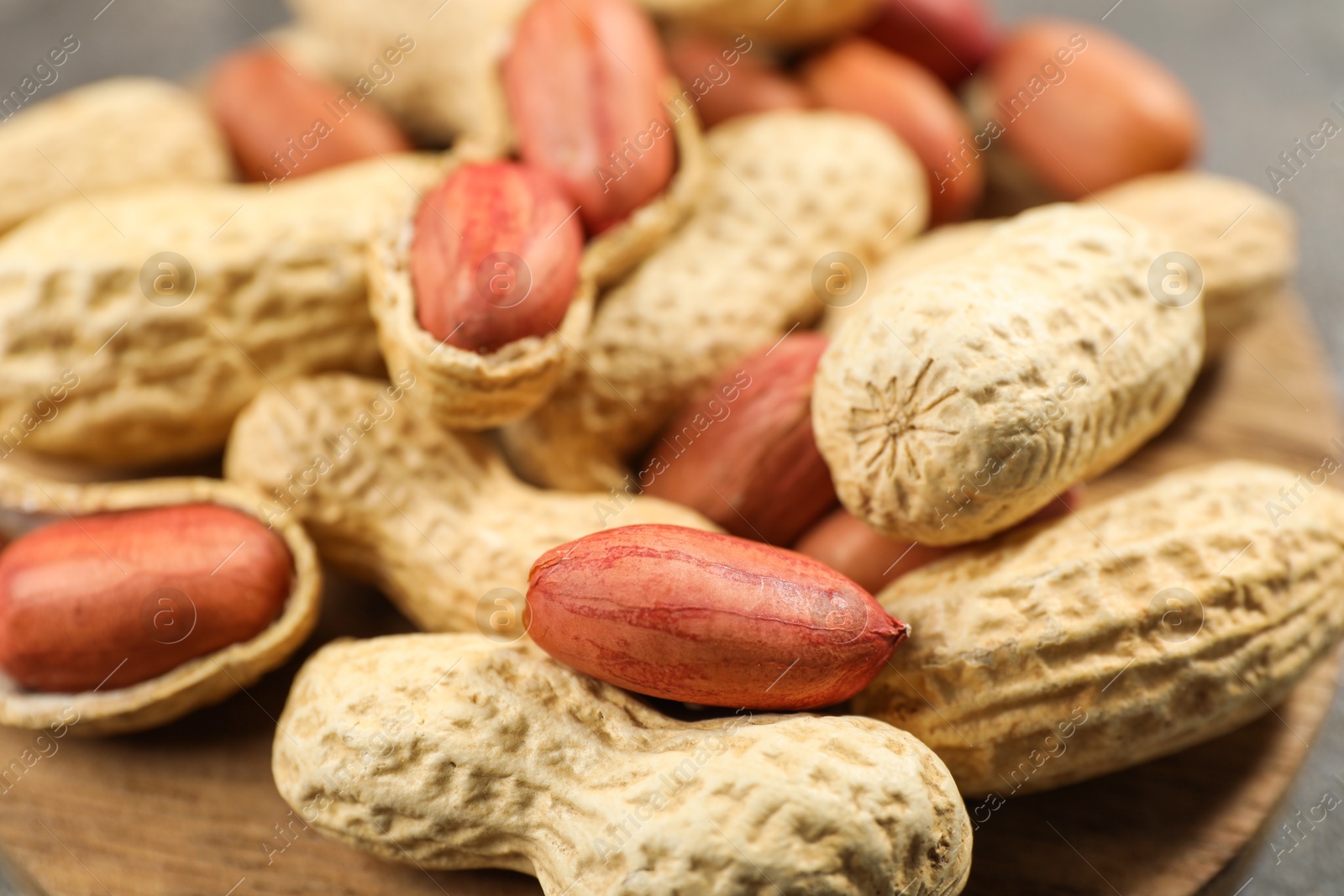 Photo of Fresh unpeeled peanuts on table, closeup view