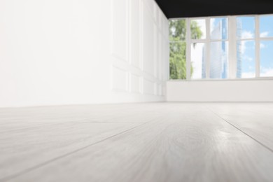 Empty room with new white laminated flooring, closeup