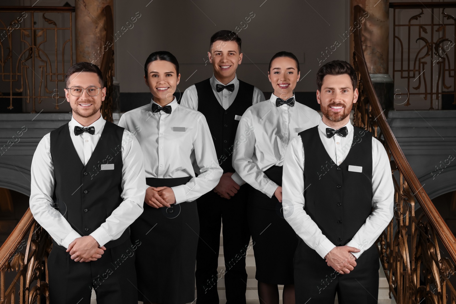 Photo of Group of trainees wearing formal clothes in hotel. Professional butler courses