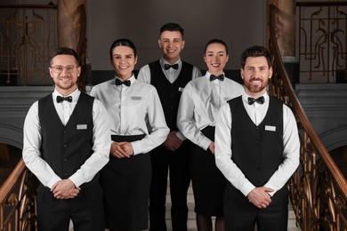 Photo of Group of trainees wearing formal clothes in hotel. Professional butler courses