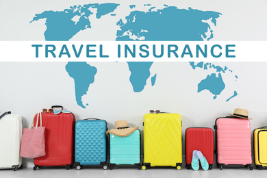 Image of Colorful suitcases and phrase TRAVEL INSURANCE on light background