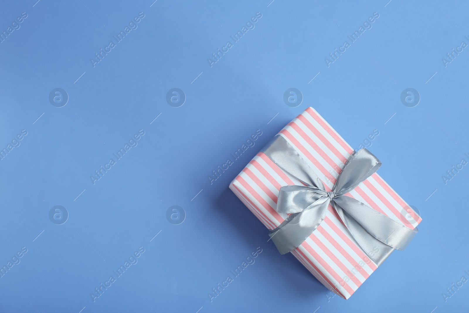 Photo of Beautifully decorated gift box on color background, top view