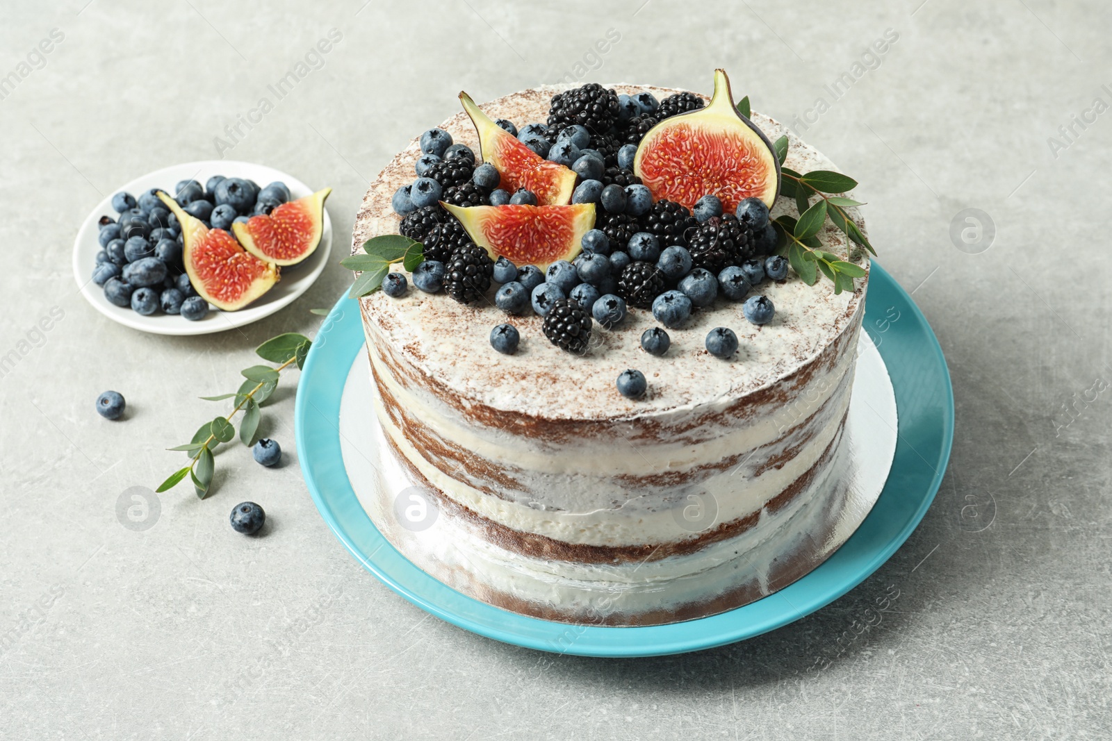 Photo of Delicious homemade cake with fresh berries on table