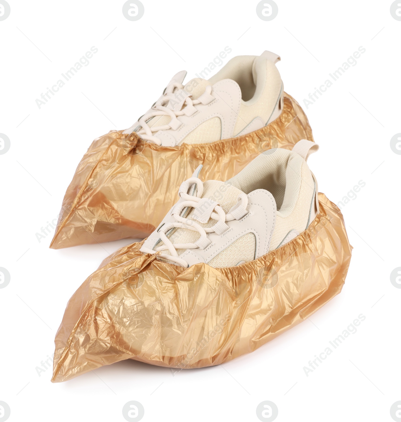 Photo of Sneakers in brown shoe covers isolated on white