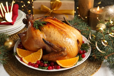 Photo of Delicious roasted turkey served for Christmas dinner on table