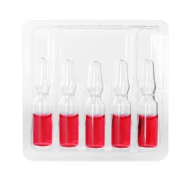 Glass ampoules with pharmaceutical product in tray on white background