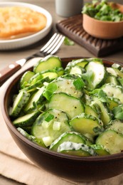 Photo of Delicious cucumber salad served on wooden table