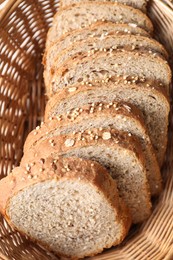 Slices of fresh homemade bread in wicker basket, closeup