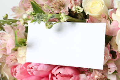 Photo of Happy Mother's Day. Beautiful flowers with blank card on light background, closeup