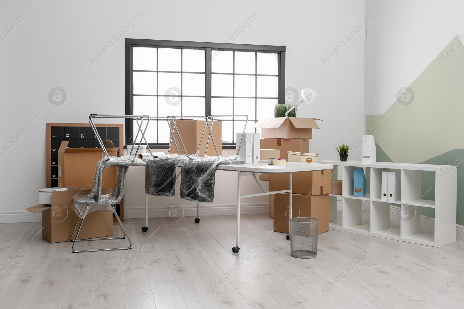 Photo of Moving boxes and furniture in new office