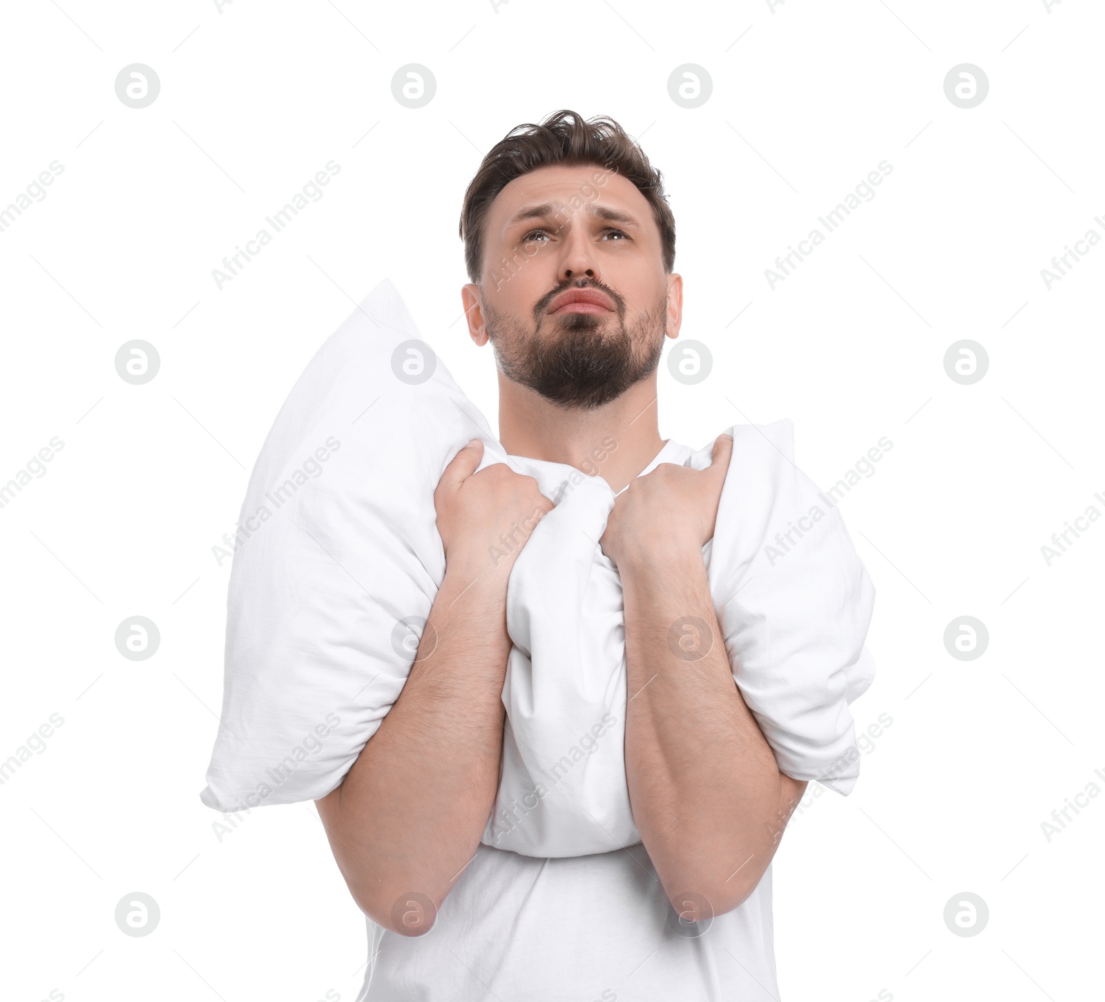 Photo of Unhappy man with pillow on white background. Insomnia problem