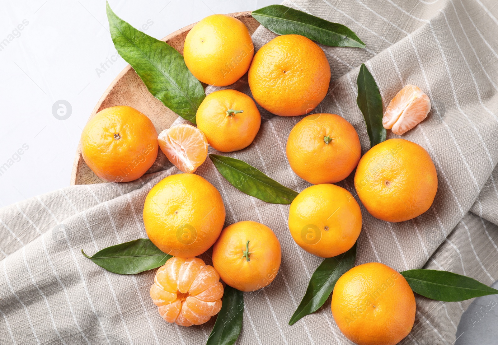 Photo of Fresh ripe tangerines on white table, flat lay