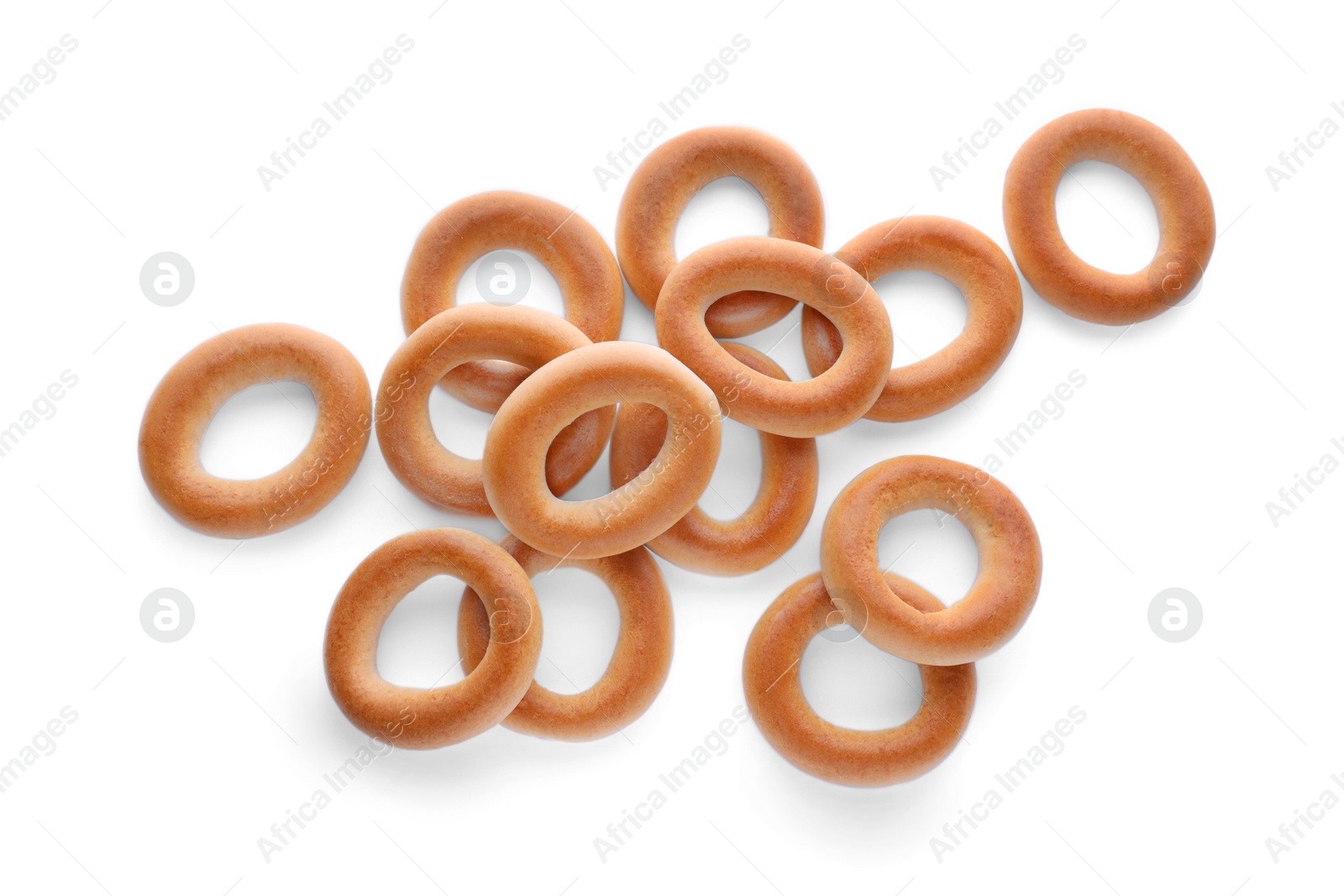 Photo of Many tasty dry bagels (sushki) isolated on white, top view