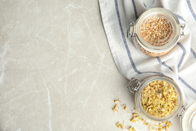 Photo of Flat lay composition with green buckwheat on light table, space for text