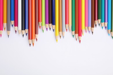 Colorful wooden pencils on white background, flat lay. Space for text