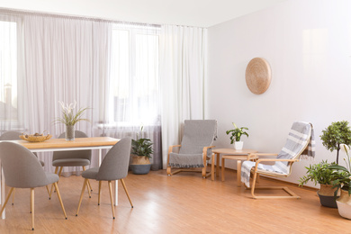 Photo of Window with stylish curtains in living room interior