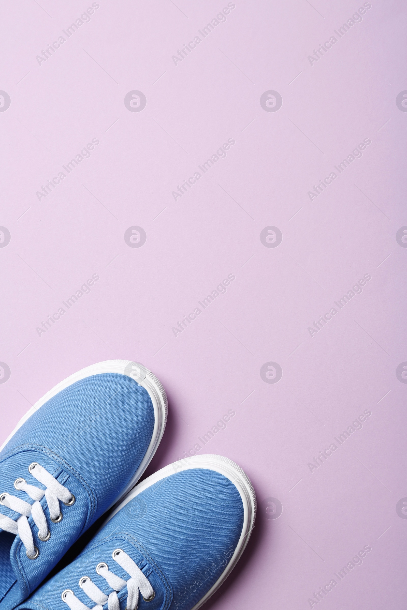 Photo of Bright stylish shoes on color background, top view. Space for text