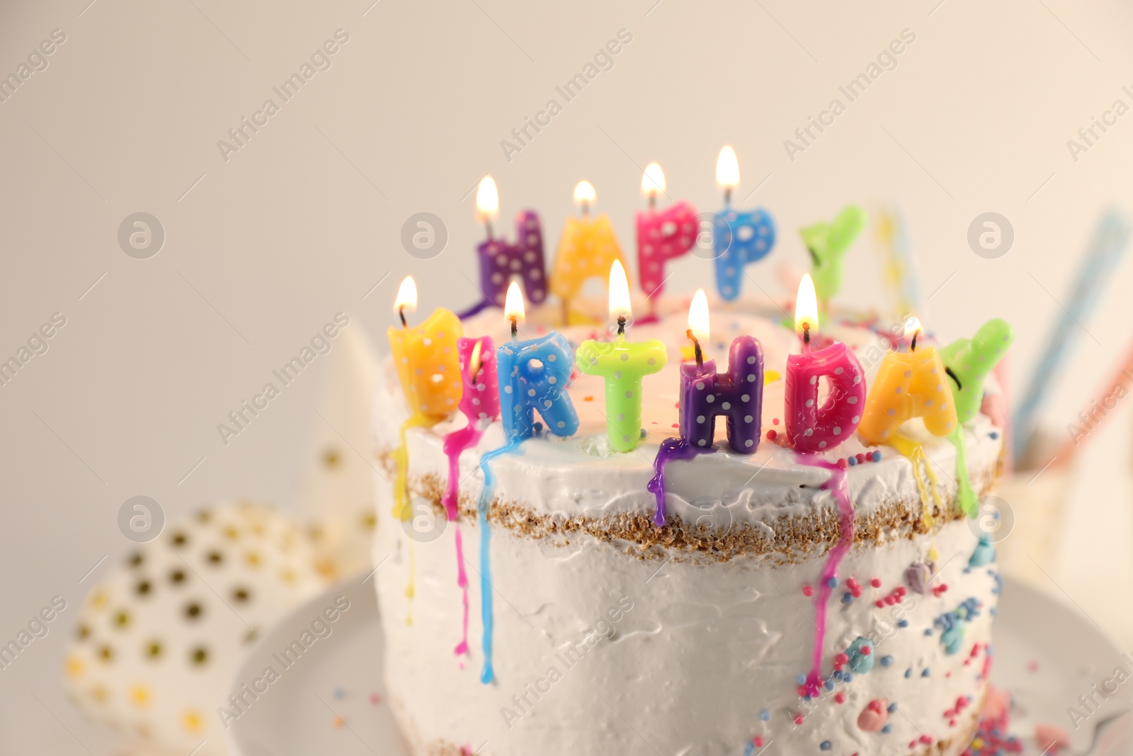 Photo of Tasty Birthday cake with burning candles on table, closeup