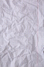 Sheet of crumpled checkered paper as background, top view