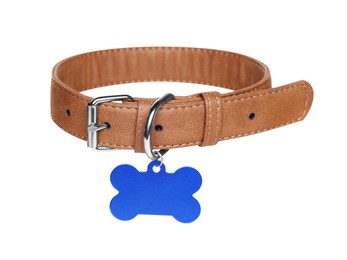 Photo of Brown leather dog collar with bone shaped tag isolated on white