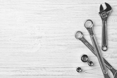 Photo of Auto mechanic's tools on white wooden background, flat lay. Space for text