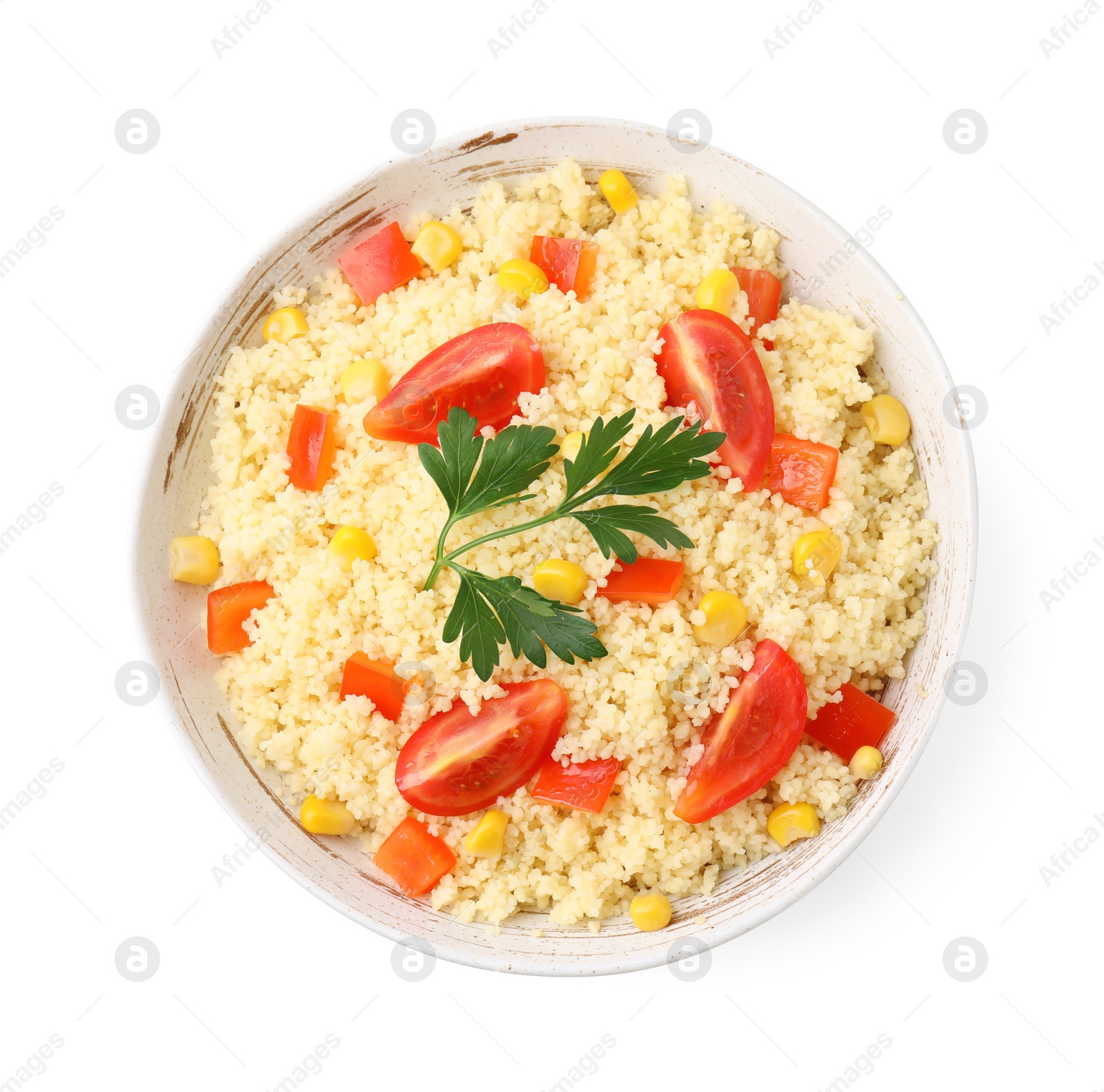 Photo of Tasty couscous with parsley, corn and tomatoes in bowl isolated on white, top view