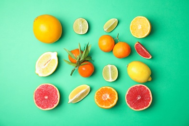 Photo of Different citrus fruits on color background, flat lay