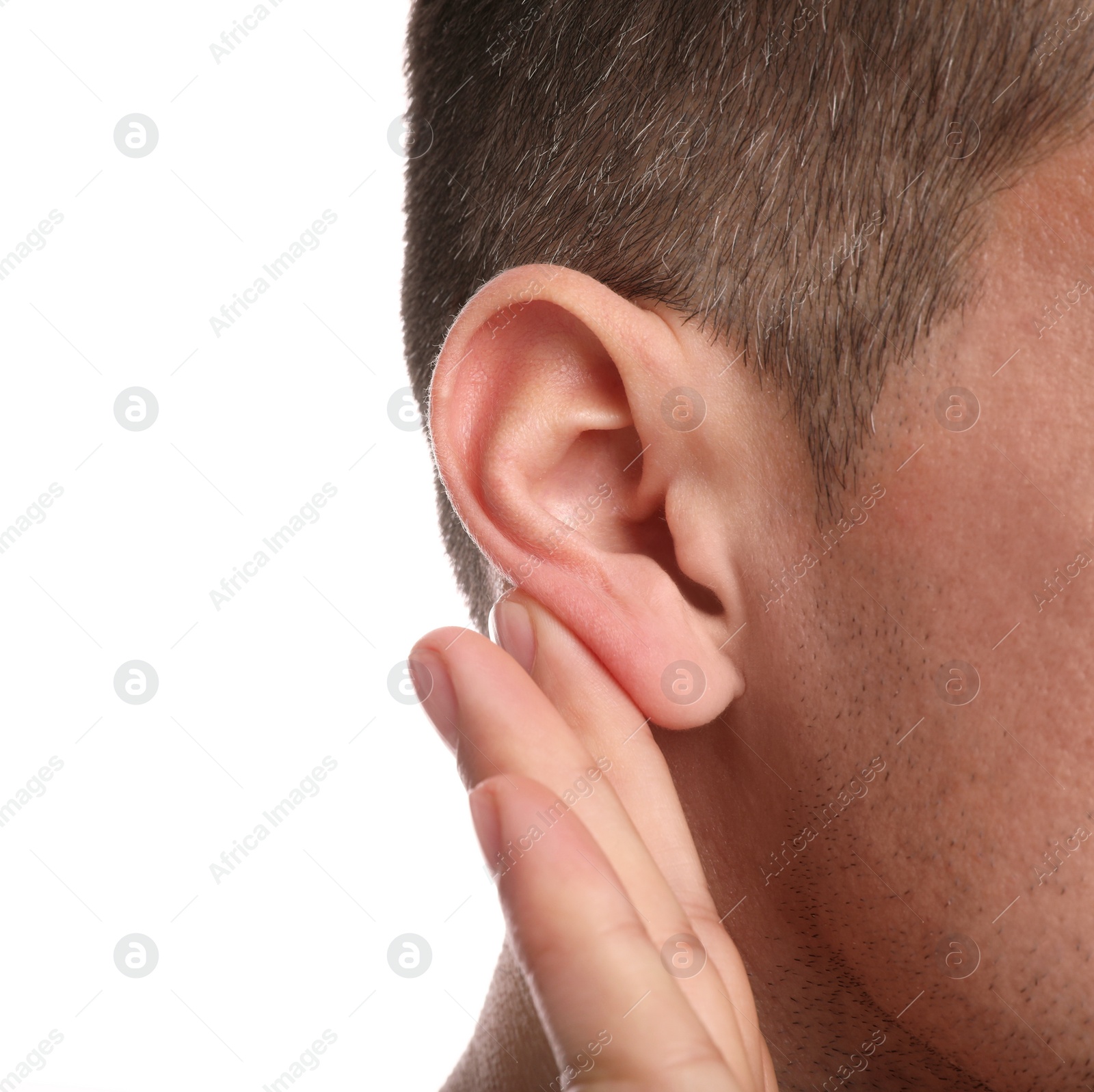 Photo of Man showing hand to ear gesture on white background, closeup