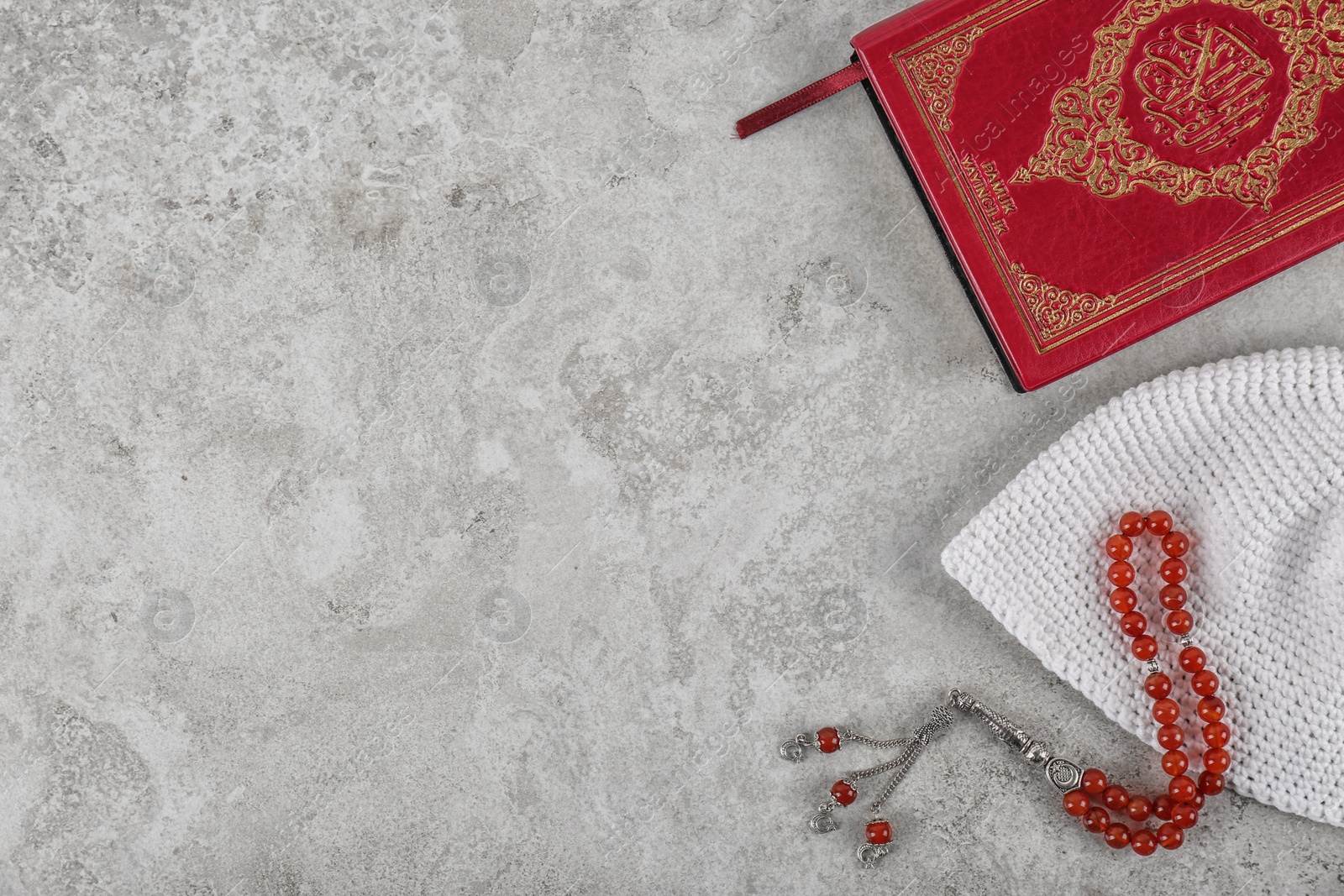 Photo of Flat lay composition with Muslim prayer beads, Quran and space for text on grey background