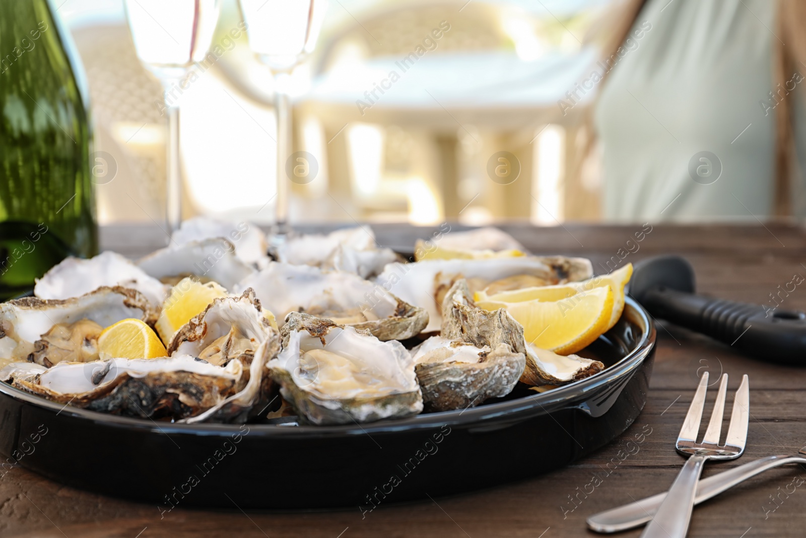 Photo of Fresh oysters with cut juicy lemon served on table