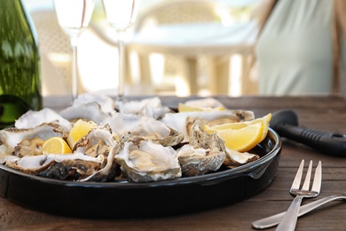 Fresh oysters with cut juicy lemon served on table