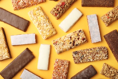 Photo of Flat lay composition with protein bars on color background