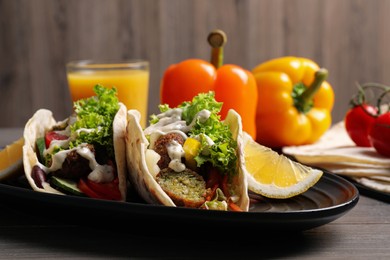 Photo of Delicious fresh vegan tacos served on wooden table
