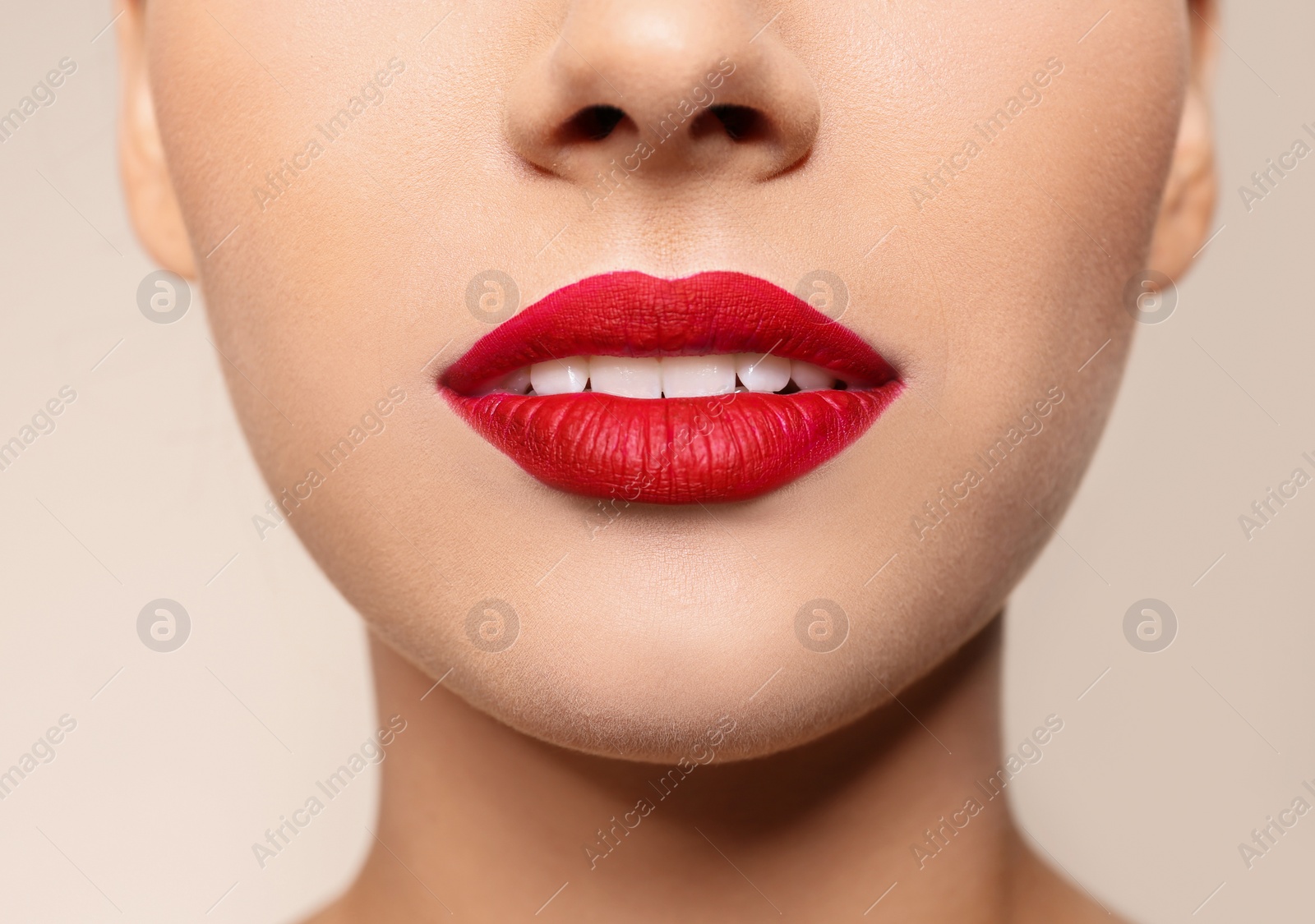 Photo of Beautiful young woman with red lips on color background, closeup