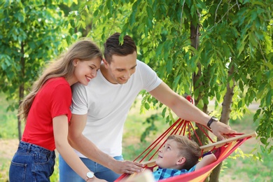 Photo of Happy couple with son spending time together outdoors