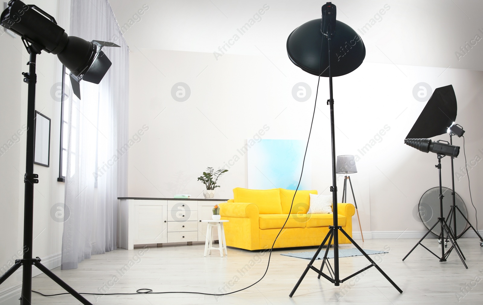 Photo of Example of living room interior design and professional equipment in photo studio