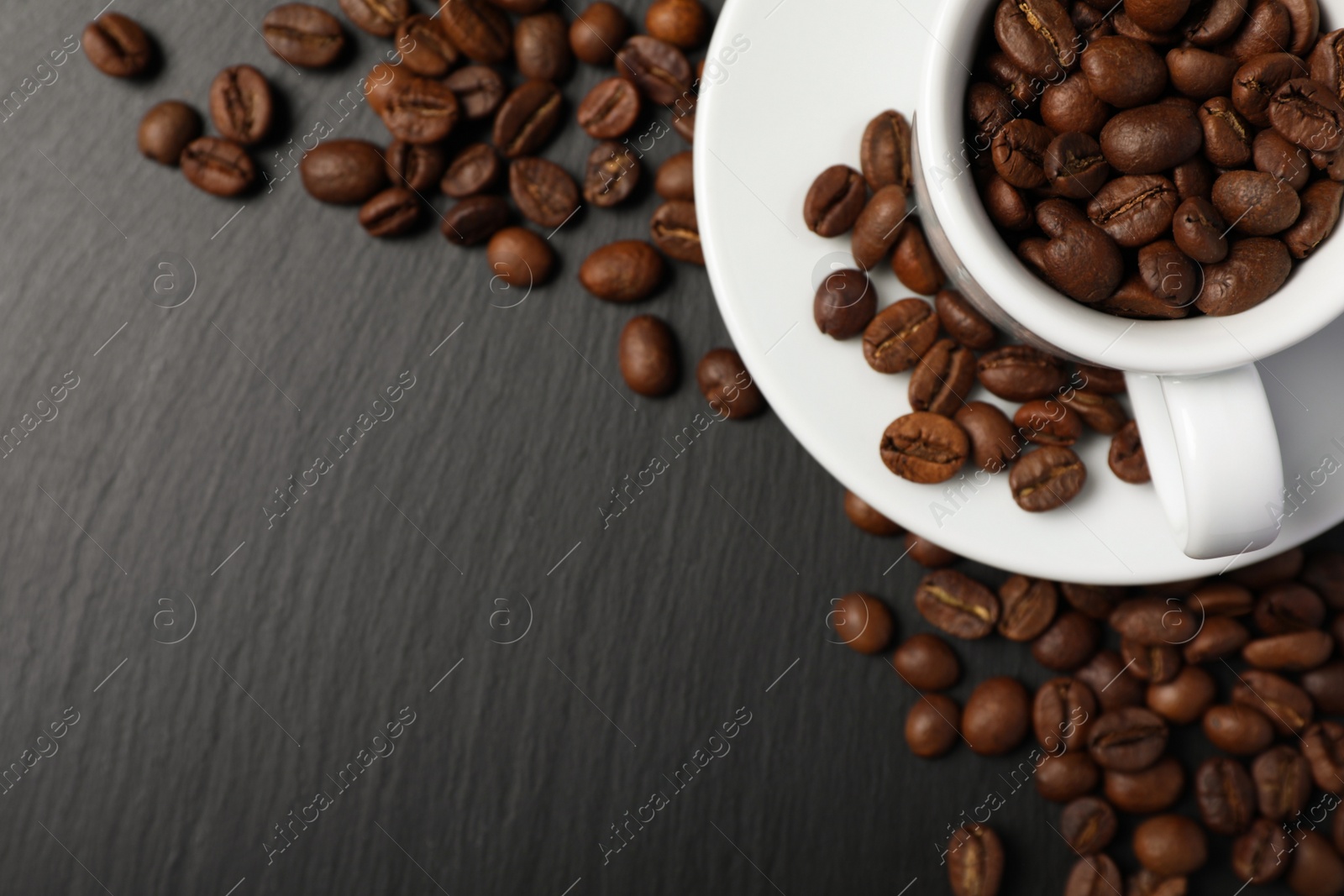 Photo of Cup and beans on black table, top view with space for text. Coffee Break