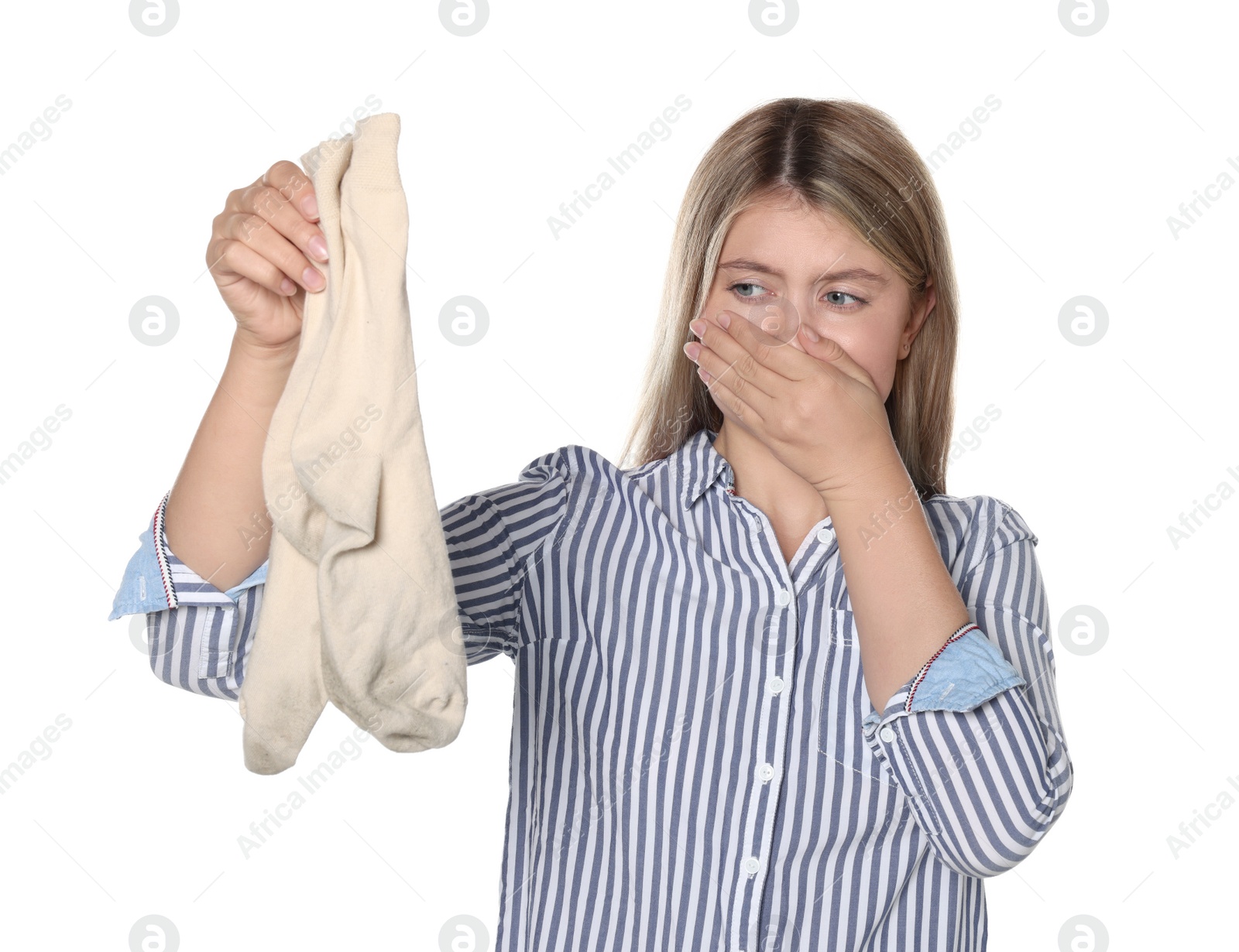 Photo of Young woman feeling bad smell from dirty socks isolated on white