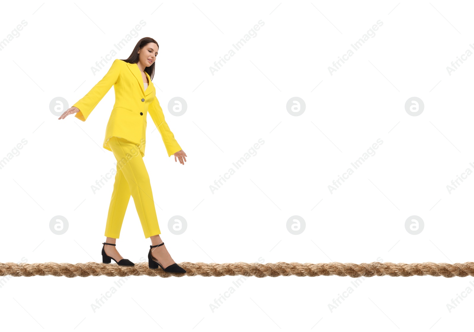 Image of Businesswoman walking rope against white background. Risk or balance concept