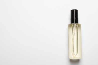 Bottle of baby oil on white background, top view. Space for text