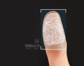 Man using biometric fingerprint scanner on black background, closeup