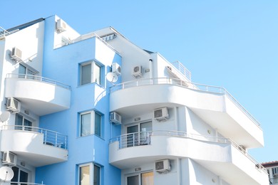 Modern building with large comfortable balconies against light blue sky