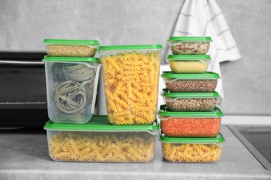 Plastic containers filled with food products on light grey countertop in kitchen