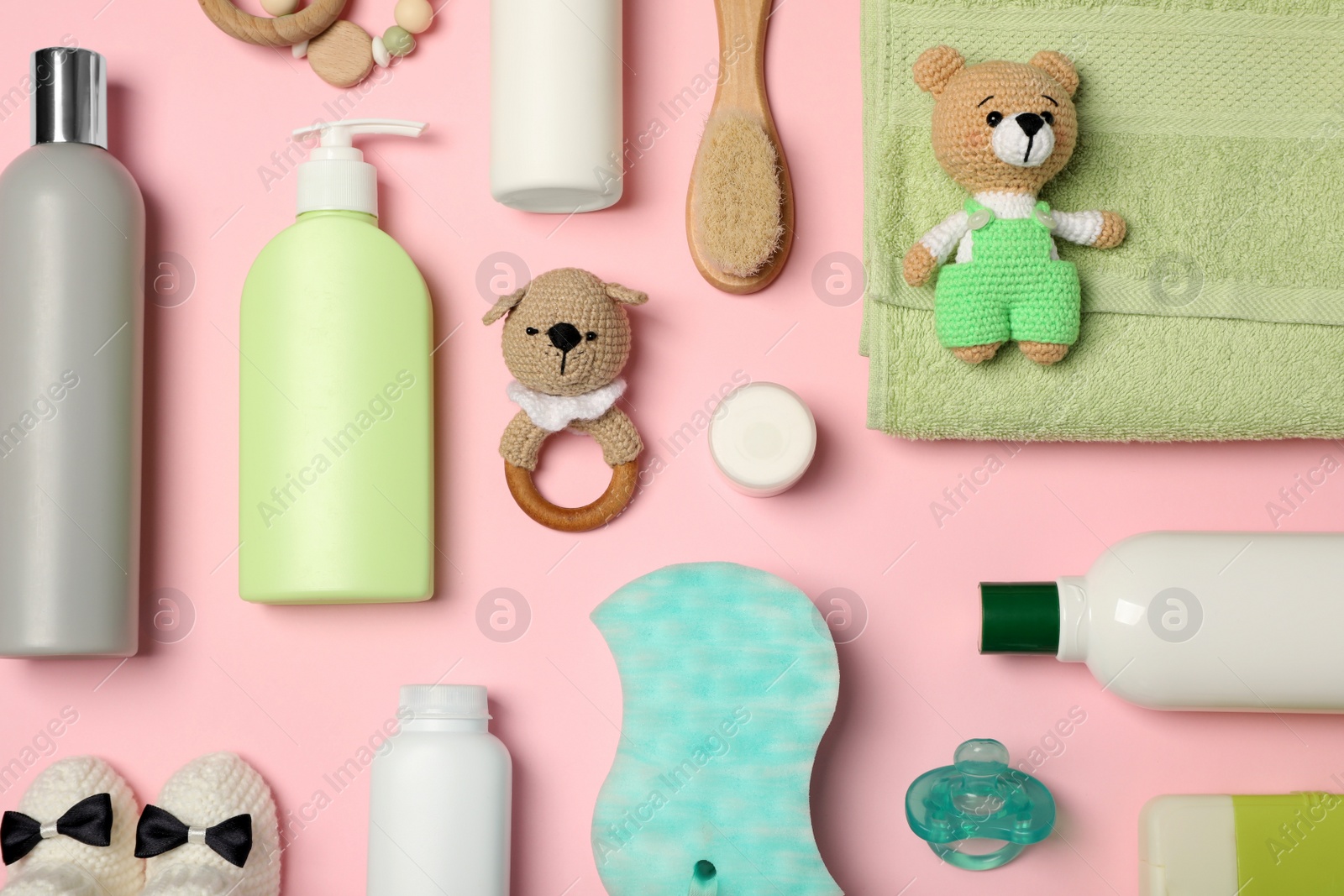 Photo of Flat lay composition with baby cosmetic products on pink background