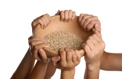 Photo of Poor people holding wooden bowl with grains on white background, closeup