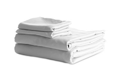 Stack of clean silky bed linen isolated on white