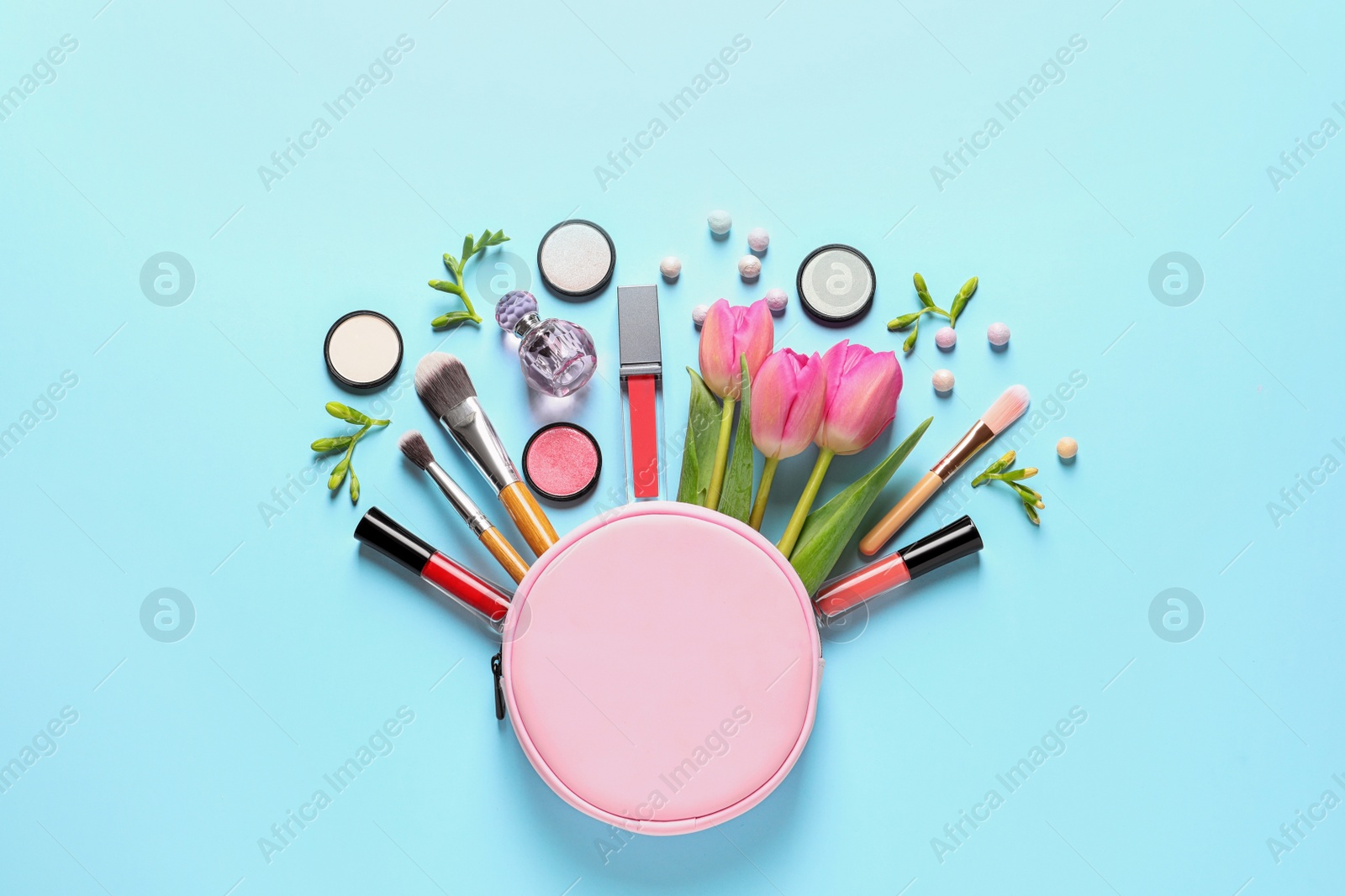 Photo of Makeup products, flowers and cosmetic bag on color background, flat lay