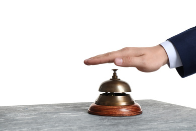 Photo of Man ringing hotel service bell at grey stone table