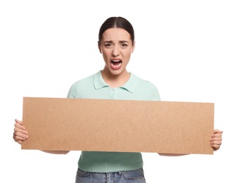 Photo of Angry young woman holding blank cardboard banner on white background, space for text